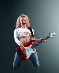 beautiful young blonde woman with a guitar sings a rock song