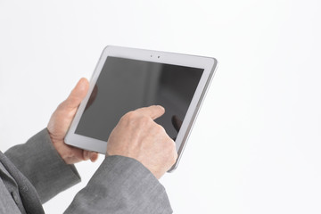 close up.businessman pointing finger at the digital tablet screen.isolated on white background