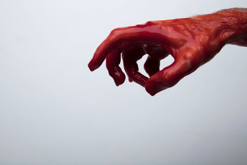 Bloody hand against a light background. halloween horror concept