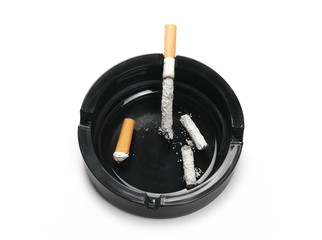 Lit cigarette in black ashtray isolated on white background