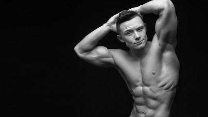 Fototapeta na wymiar Isolated black and white muscle man with a perfect abs.