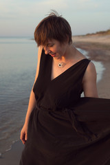 Natural portrait of a woman with a short haircut on the beach