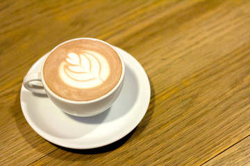 cup of coffee on wooden table