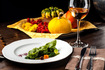 Green Ravioli with quail egg on a black background. A Halloween Feast.