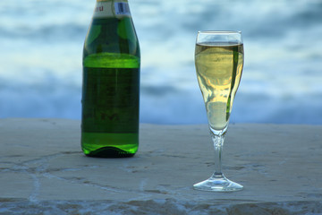 Still life of drinks (wine and cider), in nature (sea and mountain), made at dawn.