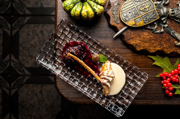 Deer steak on a black background. A Halloween Meal.