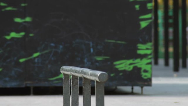 Skater jump on a rail with trick 50-50 grind, detailed view in slowmotion