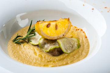 Pumpkin cream soup with fish som. A Halloween Meal.