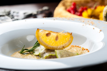 Pumpkin cream soup with fish som. A Halloween Meal.