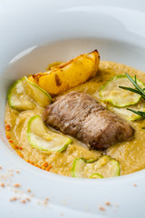 Pumpkin cream soup with fish som. A Halloween Meal.