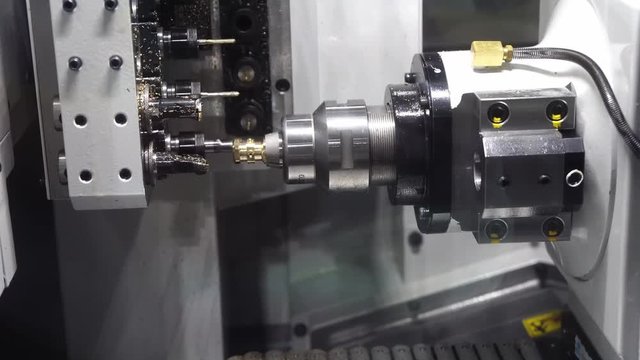 The operation of CNC lathe machine with multi-function operation.Hi-technology manufacturing process.