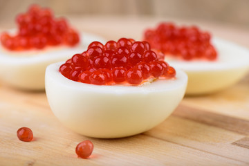 Chicken eggs with red caviar selective focus