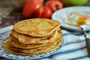Traditional Russian pancakes blini on a rustic plate