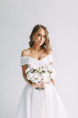 A concept wedding, contemporary European bride. Bouquet of flowers, fees in the interior Studio....