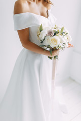 A concept wedding, contemporary European bride. Bouquet of flowers, fees in the interior Studio....