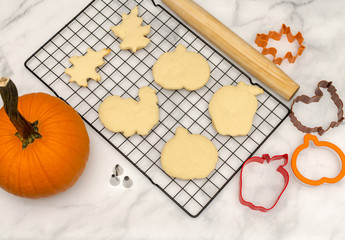 Top view baking for fall celebrations.  Holiday cookies background with cutters and rolling pins.