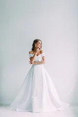 A concept wedding, contemporary European bride. Bouquet of flowers, fees in the interior Studio. Ideas for a minimalist wedding, white color © pavelvozmischev