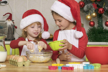 Fototapeta na wymiar The girls make cookies for Christmas
