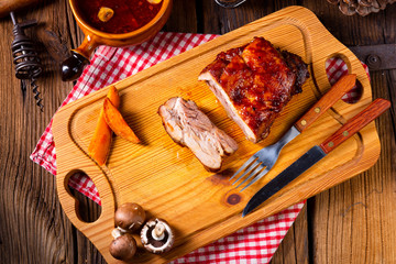 spicy roasted meat with mushroom sauce in the oven