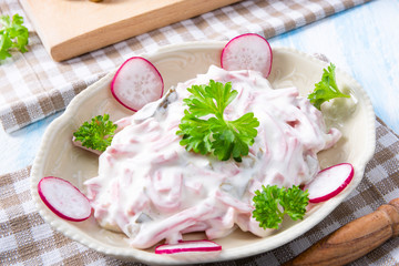 delicious homemade meat salad with mayonnaise and cucumber