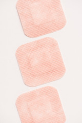 top view of row of adhesive bandages on white surface