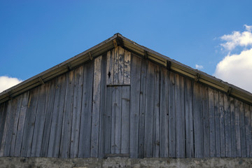 Fototapeta na wymiar Old farm roof and blue sky