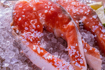 salmon steak raw in ice, closeup