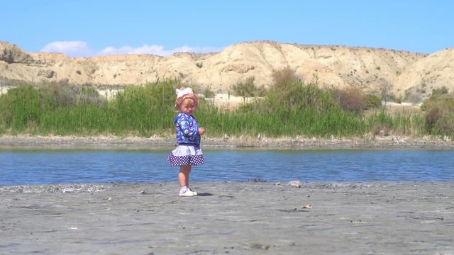the child stands at the lake