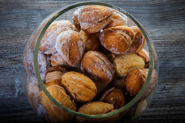 closeup handmade baked nuts with boiled condensed milk in glass jar