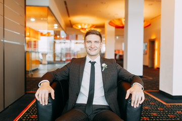 Stylish minimalism in the image of the groom. Black color and European wedding. The preparations of...