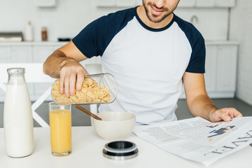 cropped shot of man having breakfast in kitchen at home