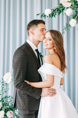 Stylish European wedding ceremony. The bride and groom are surrounded by guests. Arch and decor of...