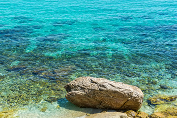 Fototapeta premium Turquoise Seawater surface and beach in Greece