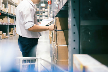 Man warehouse worker checking goods at warehouse.