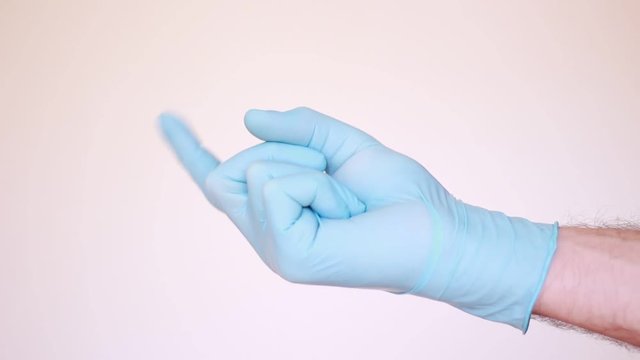 Forefinger in latex glove pointing and calling