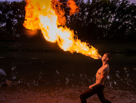  Man fire-eater blowing a large flame