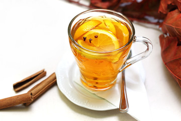 Cytrusowa herbata.  Filiżanka herbaty z pomarańczami, cytryną, goździkami i korą cynamonu. - obrazy, fototapety, plakaty