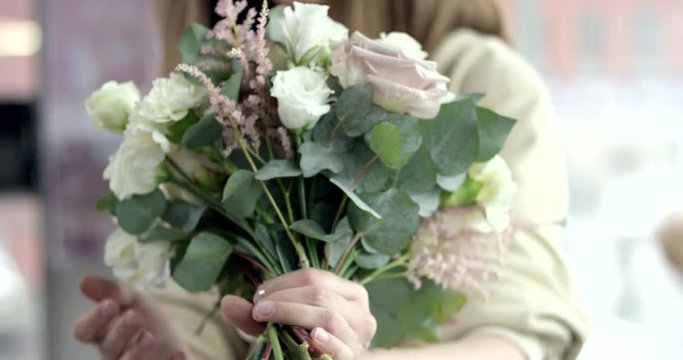 Young Florist Assembles a Rustic Wedding Bouquet. Young florist assembles a perfect wedding bouquet. Her flowers are wonderful, the colors are so rustic, she has perfect taste. She's happy 