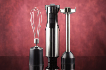 Blender with accessory on the red mirror background