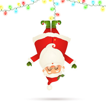Smiling Santa Claus cartoon character hanging upside down with garland string of twinkle lights with multicolored bulbs isolated on white background. Santa clause for winter and new year holidays.