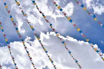 Prayer flags and clouds at the Shuangqiao Valley, Sichuan, China  