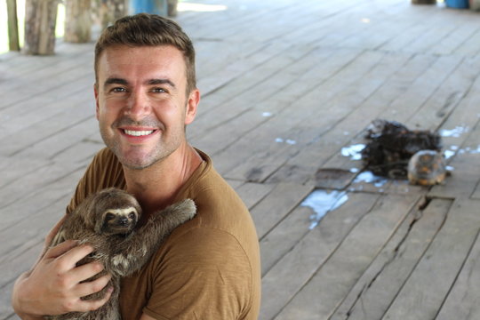 Sloth hugging a handsome man