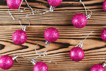 Lot of scattered red christmas balls on old wooden table. Top view