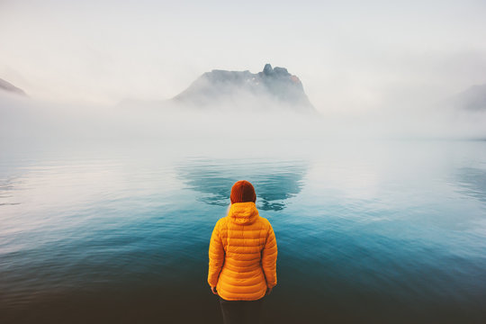 Woman looking at foggy sea