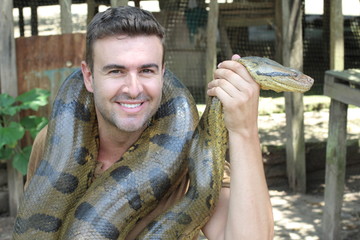 Fototapeta premium Man with a giant Anaconda around his neck