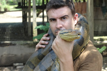 Man with a giant Anaconda around his neck