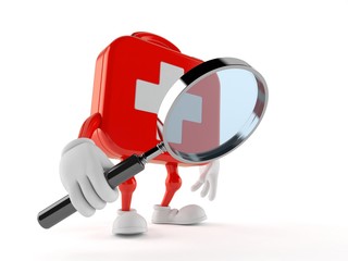 First aid kit character looking through magnifying glass