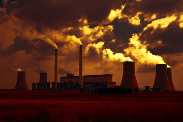 Power station in the yellow glow of sunset.