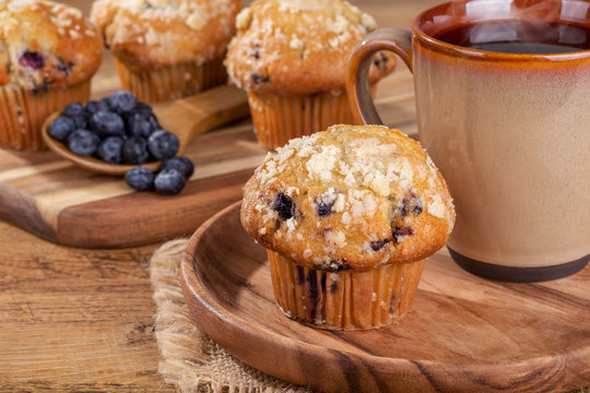 Blueberry Muffin And Cup Of Coffee On A Wooden Plate