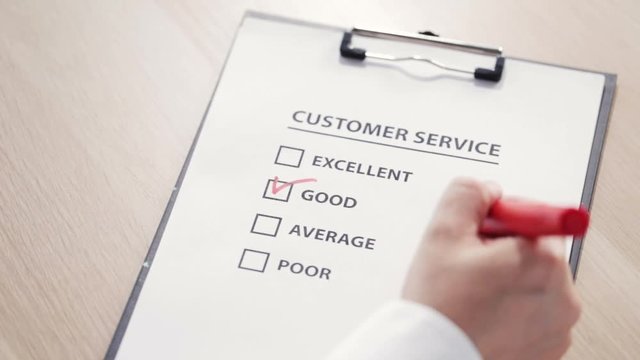 Man putting a check sign at "good" square at a customer satisfaction survey